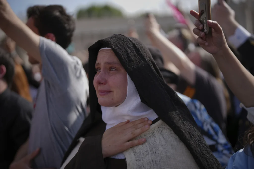 A nun cries as the body of Pope Francis is carried into St. Peter’s Basilica at the Vatican, Wednesday, April 23, 2025, where he will lie in state for three days.