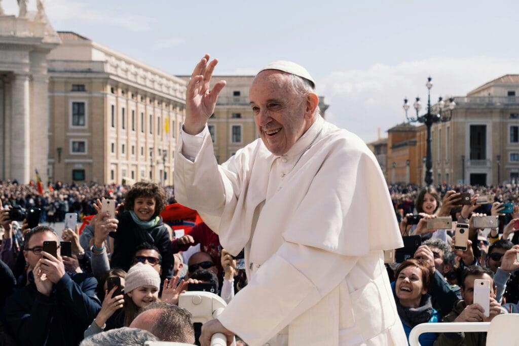 Pope Francis waving to people in Vatican City